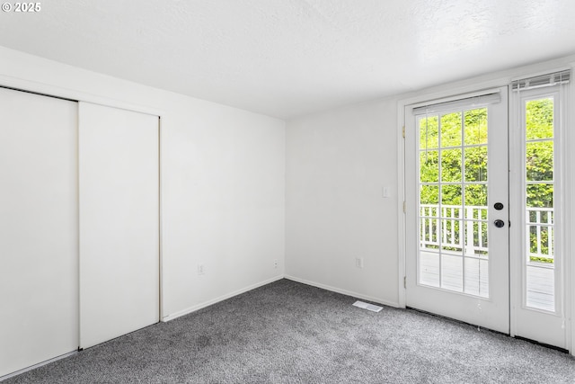 7733 NE Mason St, Portland, OR 97218 - unfurnished bedroom with access to outside, carpet floors, a textured ceiling, and a closet