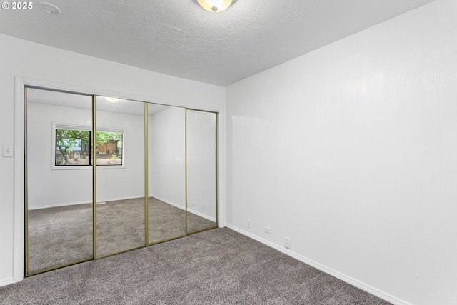 7733 NE Mason St, Portland, OR 97218 - unfurnished bedroom with carpet floors, a textured ceiling, and a closet