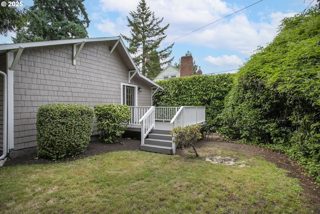 7733 NE Mason St, Portland, OR 97218 - view of home's exterior with a deck and a yard