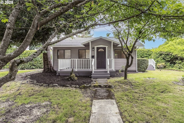 7733 NE Mason St, Portland, OR 97218 - ranch-style home featuring a porch, a front yard, and a shingled roof