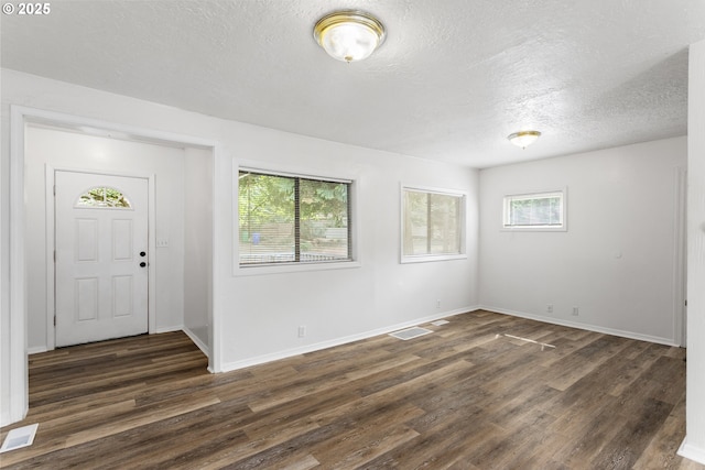 7733 NE Mason St, Portland, OR 97218 - foyer entrance featuring dark wood-style flooring and a textured ceiling