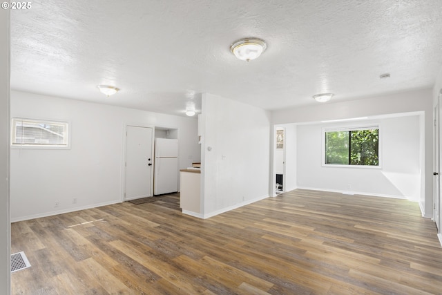 7733 NE Mason St, Portland, OR 97218 - unfurnished room featuring a textured ceiling and wood finished floors