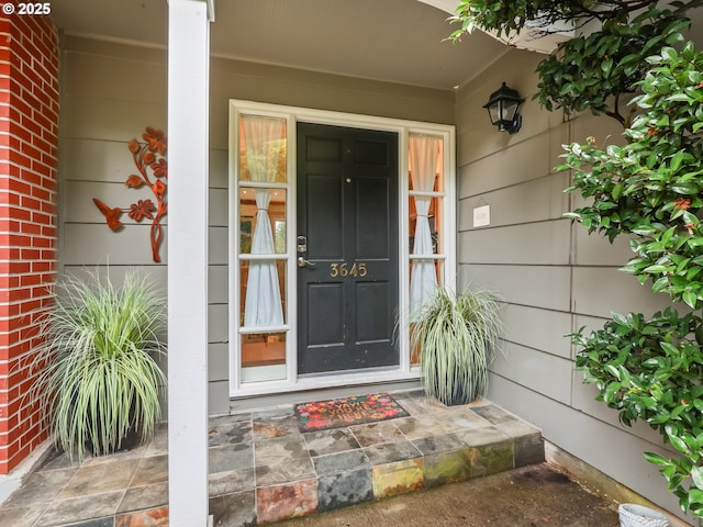 doorway to property featuring covered porch