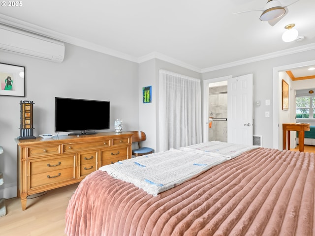 bedroom with visible vents, ensuite bathroom, a wall unit AC, crown molding, and light wood finished floors