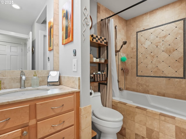 bathroom with tiled shower / bath, toilet, and vanity