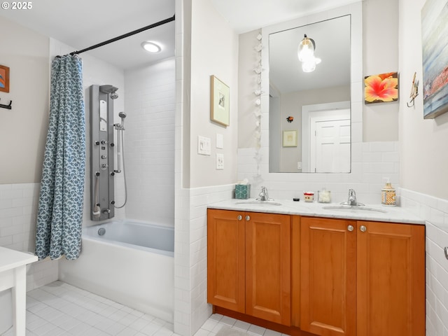 bathroom with tile walls, shower / tub combo, double vanity, and a sink