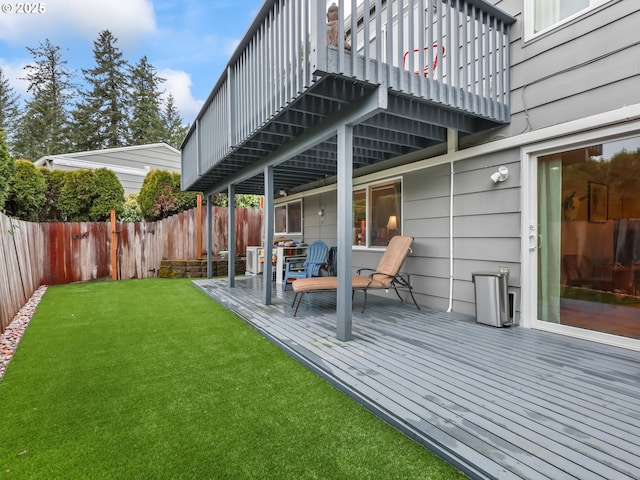 wooden deck with a fenced backyard and a yard