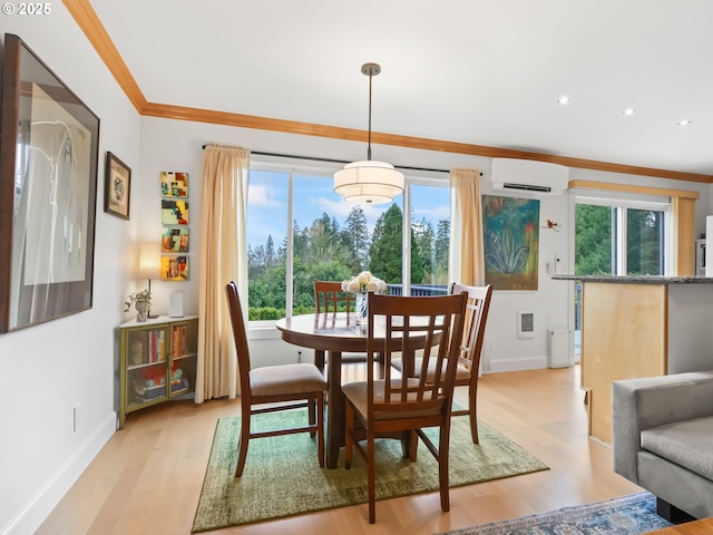 dining space featuring a wall mounted air conditioner, light wood-type flooring, recessed lighting, crown molding, and baseboards