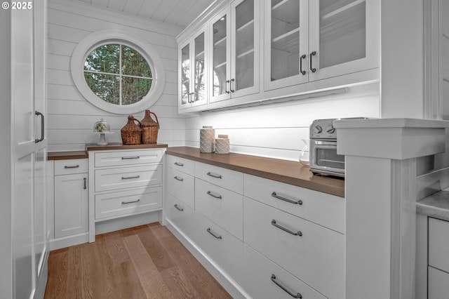 kitchen featuring white cabinetry, light hardwood / wood-style flooring, and butcher block counters