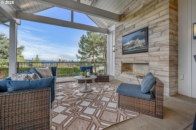 view of patio / terrace featuring an outdoor living space with a fireplace