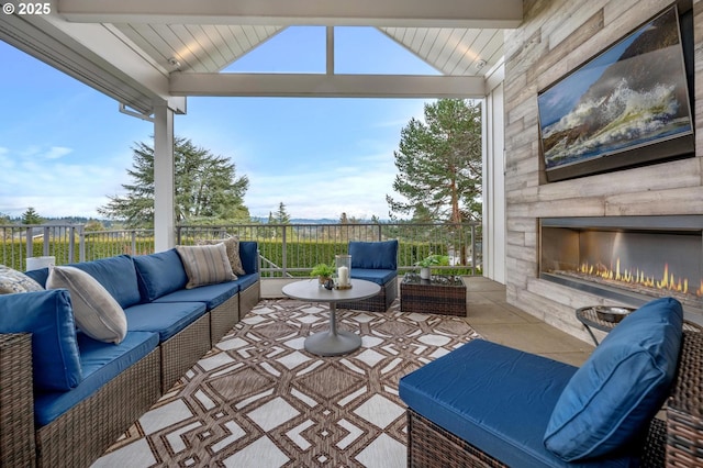 view of patio featuring an outdoor living space with a fireplace