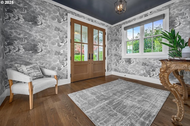 entryway with french doors, ornamental molding, and dark wood-type flooring