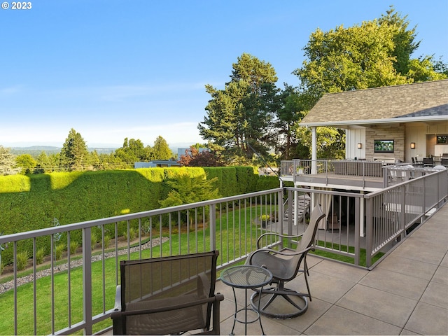 wooden balcony featuring a patio and a deck