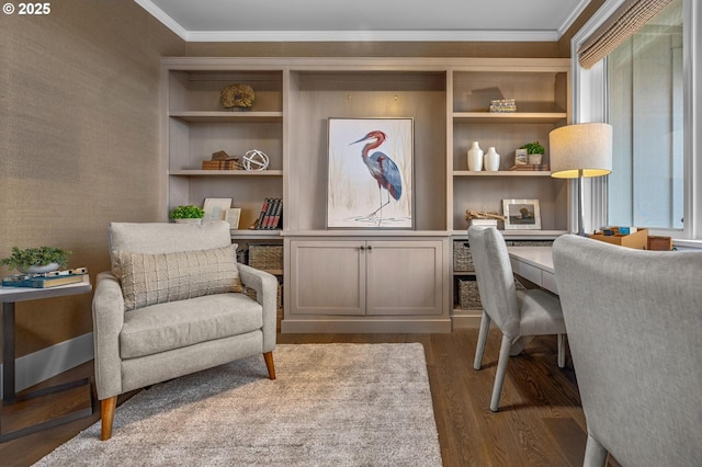 office featuring hardwood / wood-style flooring, crown molding, and built in desk