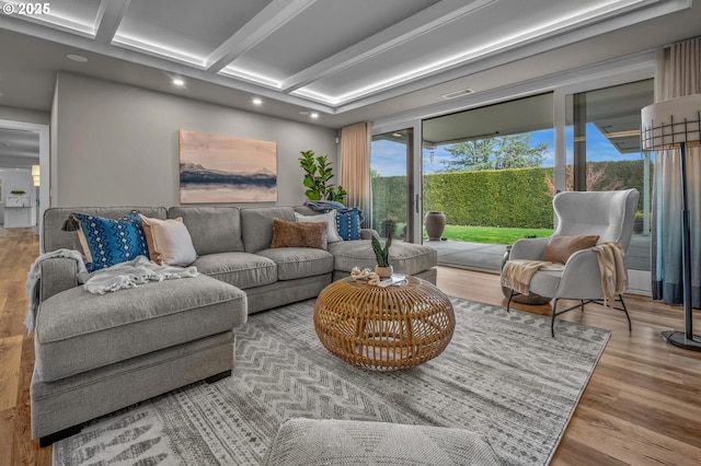 living room featuring beam ceiling and light hardwood / wood-style flooring