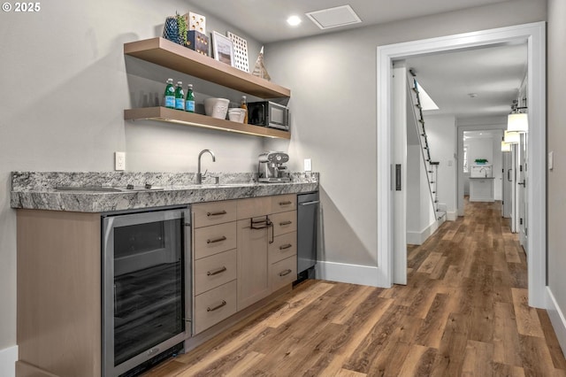 bar with wine cooler, light brown cabinetry, sink, and dark hardwood / wood-style floors