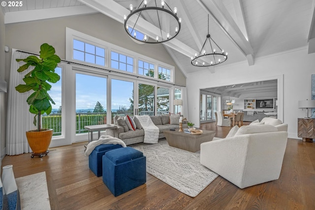 living room featuring plenty of natural light, dark hardwood / wood-style flooring, and a notable chandelier