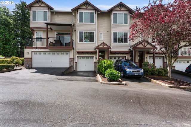 736 NW 118th Ave Unit 102, Portland, OR 97229 - townhome / multi-family property featuring driveway, an attached garage, and stone siding