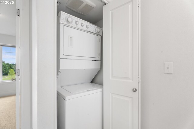 736 NW 118th Ave Unit 102, Portland, OR 97229 - washroom featuring stacked washer / dryer and carpet flooring