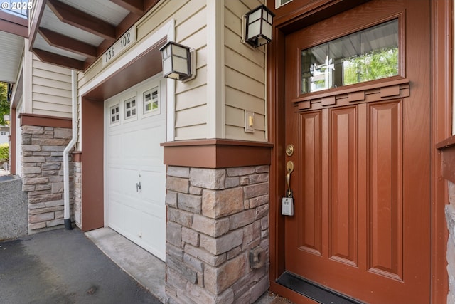 736 NW 118th Ave Unit 102, Portland, OR 97229 - view of exterior entry featuring a garage and stone siding