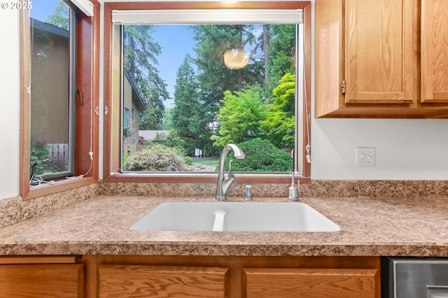 kitchen view of a sink and light countertops