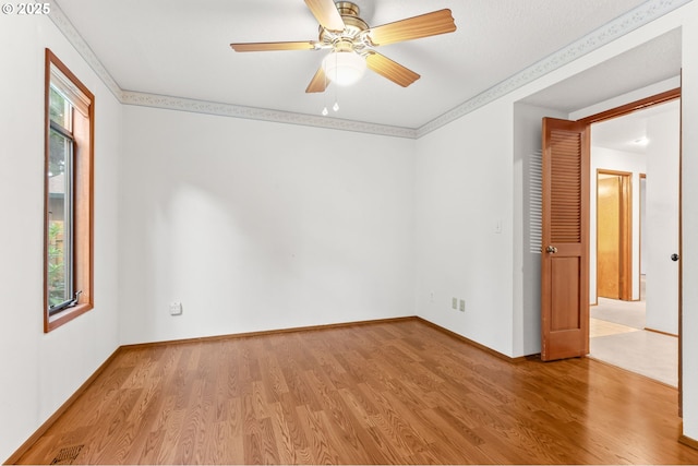 spare room with light wood-style flooring, baseboards, and ceiling fan