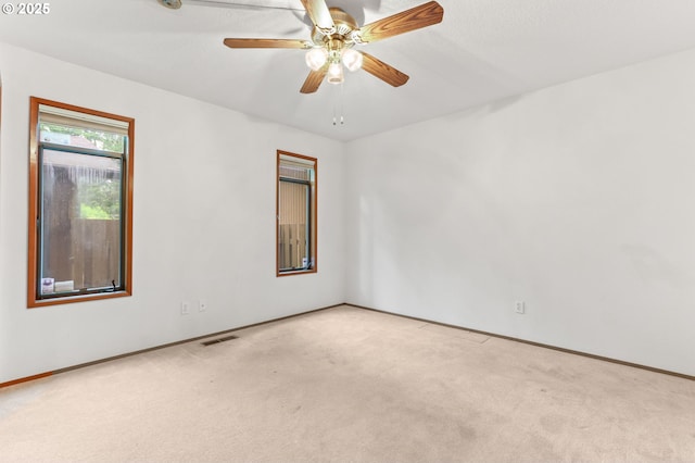 carpeted empty room with baseboards and ceiling fan