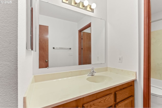 bathroom featuring vanity and toilet
