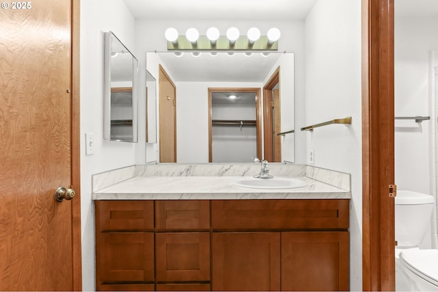 bathroom featuring toilet and vanity