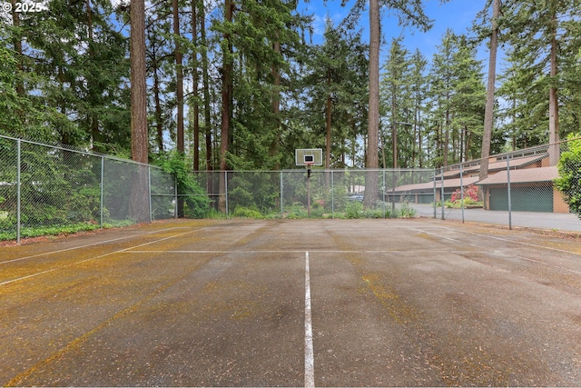 view of basketball court featuring fence