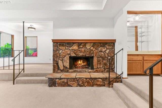 living room with carpet and a fireplace