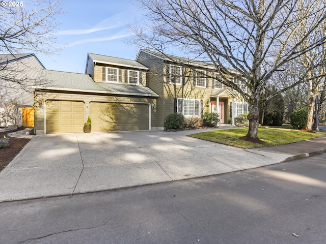 view of front of home with a garage and a front yard