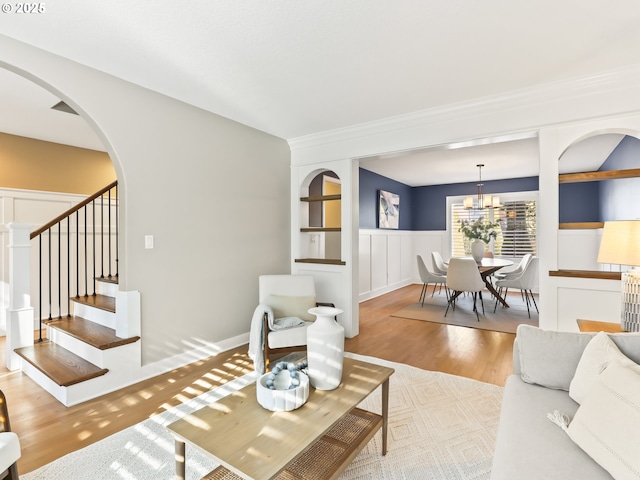 living room with an inviting chandelier and light hardwood / wood-style floors