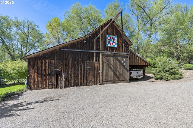 view of barn with gravel driveway