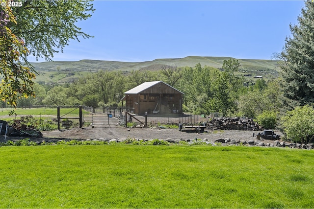view of home's community with a mountain view and an outdoor structure