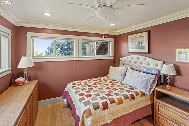 bedroom with light wood-type flooring, crown molding, ceiling fan, and recessed lighting