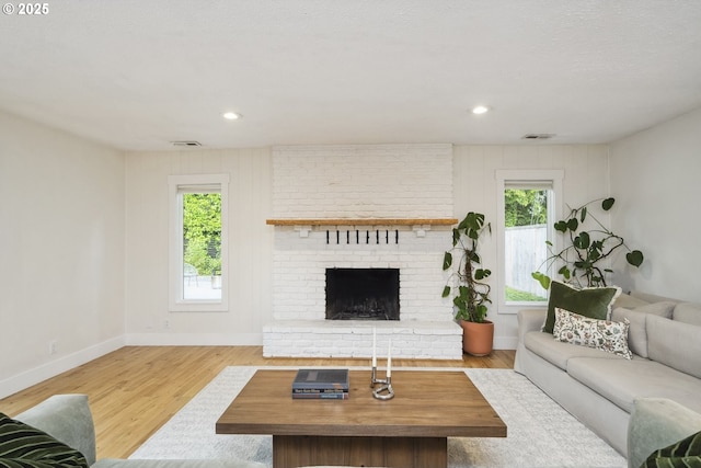 25 SW 143rd Ave, Beaverton, OR 97006 - living area with wood finished floors, plenty of natural light, baseboards, a brick fireplace, and recessed lighting