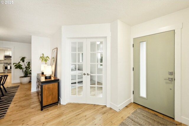 25 SW 143rd Ave, Beaverton, OR 97006 - entryway featuring light wood-style floors, french doors, and baseboards