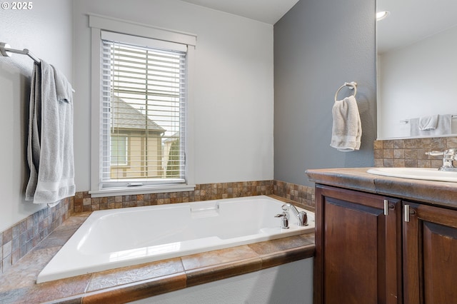 full bath with plenty of natural light, vanity, and a garden tub