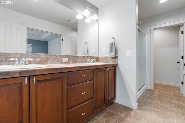 full bathroom featuring a sink, visible vents, backsplash, and tile patterned flooring