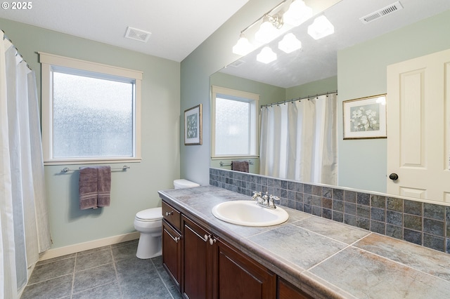 bathroom with visible vents, tasteful backsplash, vanity, and toilet