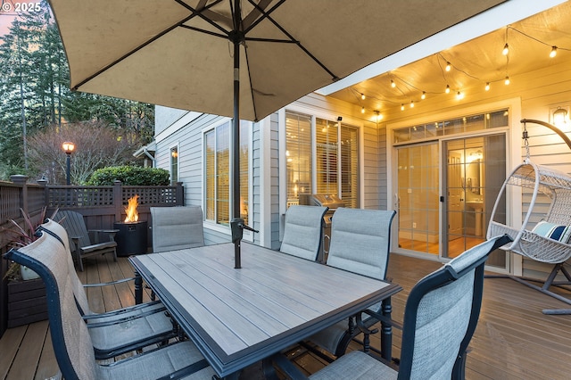 wooden terrace featuring outdoor dining space