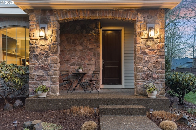 entrance to property featuring stone siding