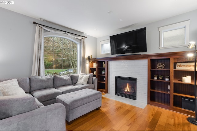 living area with a fireplace and light wood finished floors