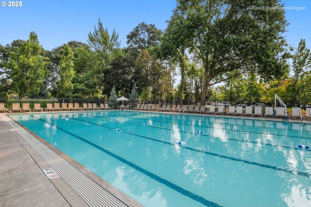 community pool featuring a patio and fence