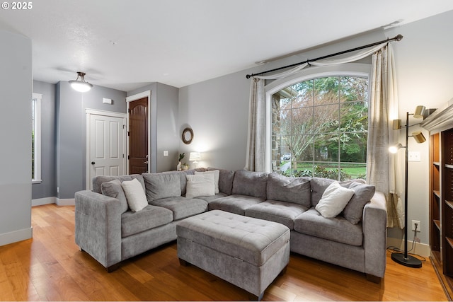 living room featuring baseboards and wood finished floors