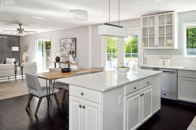 2136 SE Kelly Ave, Gresham, OR 97080 - kitchen featuring dishwasher, a textured ceiling, a center island, dark wood-type flooring, and light countertops