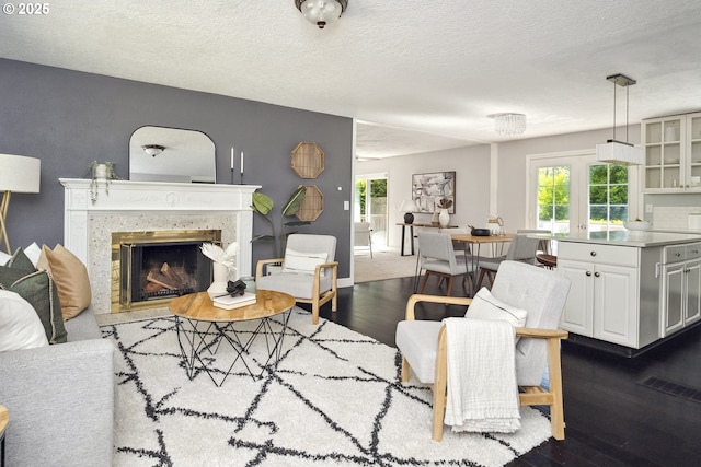 2136 SE Kelly Ave, Gresham, OR 97080 - living area featuring dark wood finished floors, healthy amount of natural light, a premium fireplace, and a textured ceiling
