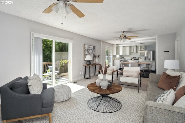 2136 SE Kelly Ave, Gresham, OR 97080 - living area with a ceiling fan, plenty of natural light, a textured ceiling, and light colored carpet