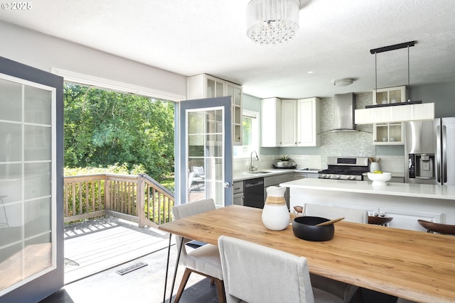2136 SE Kelly Ave, Gresham, OR 97080 - kitchen featuring appliances with stainless steel finishes, wall chimney exhaust hood, plenty of natural light, and decorative backsplash